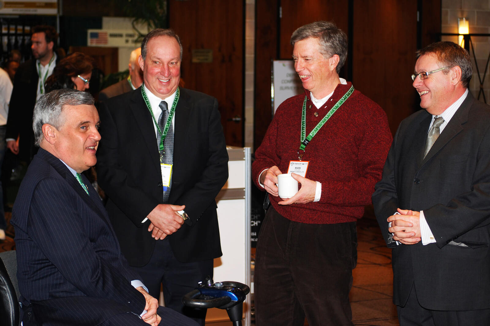 four men in conversation