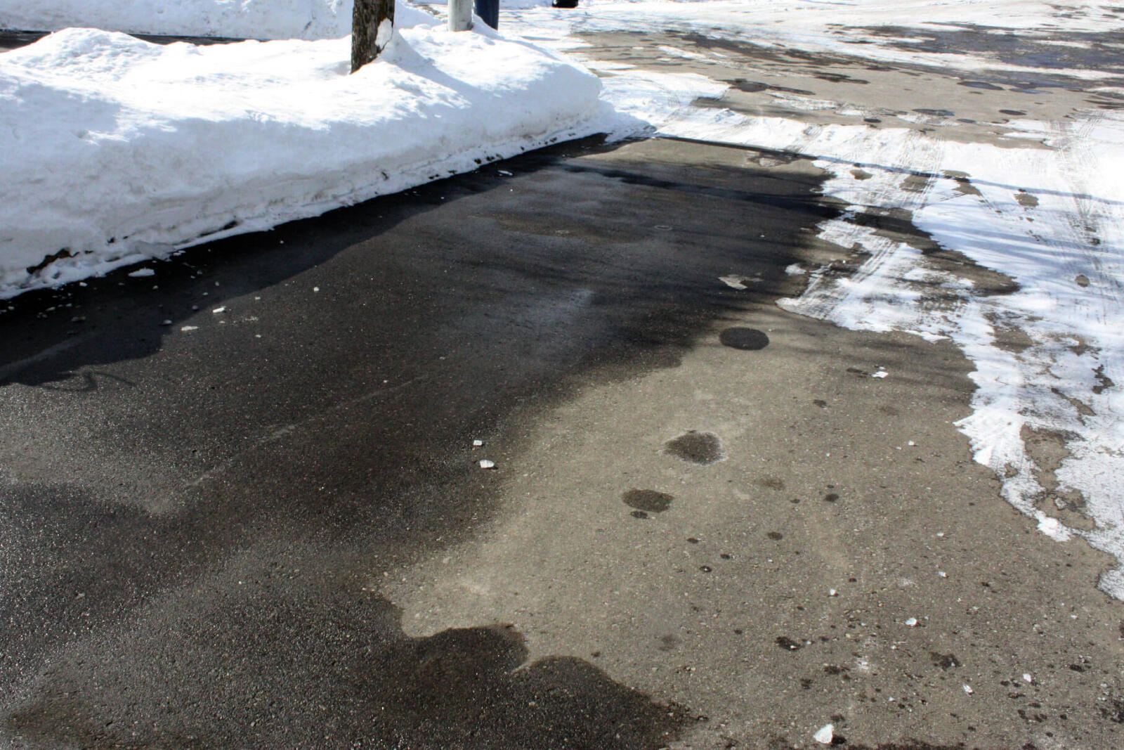partially melted snow on a driveway