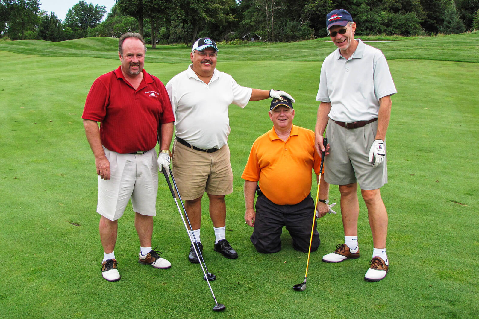 4 men on a golf course