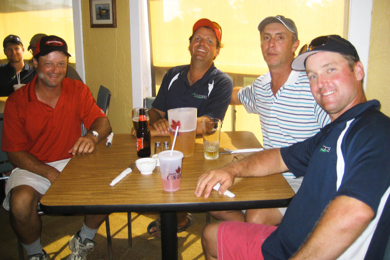 4 men sitting at a table
