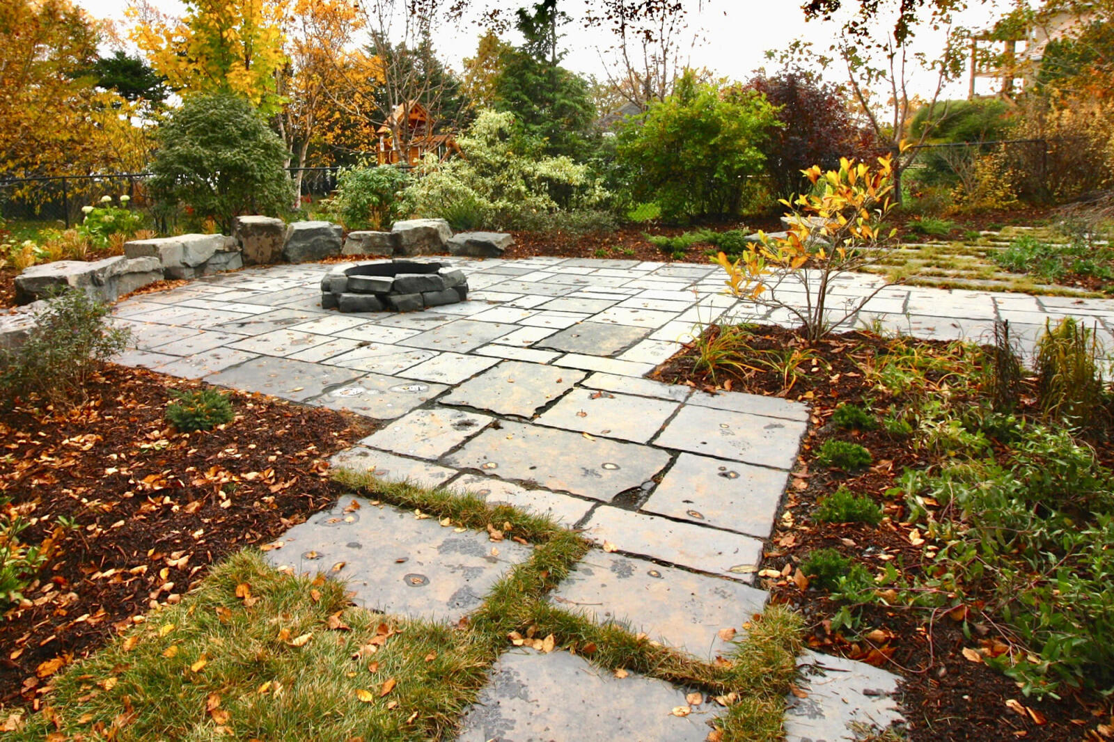 large outdoor stone patio with firepit