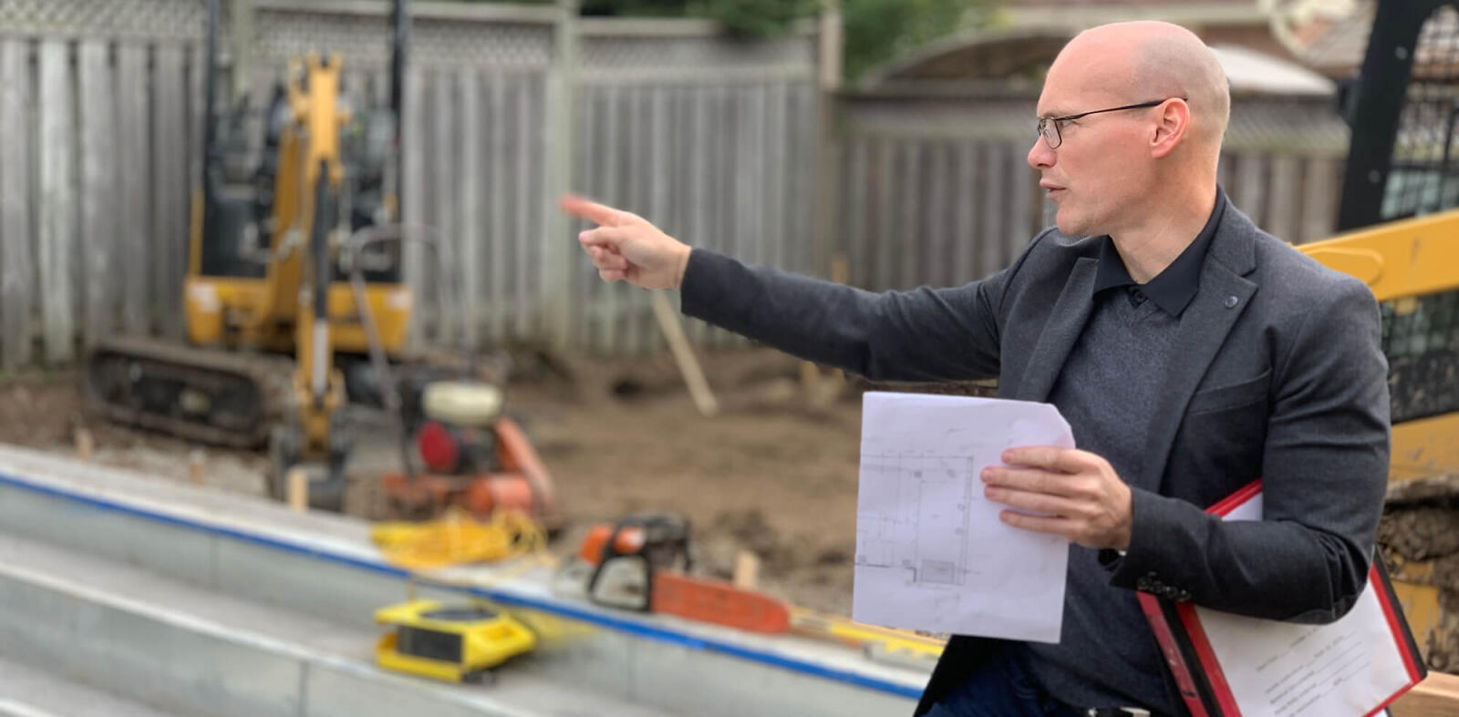 man on a job site pointing