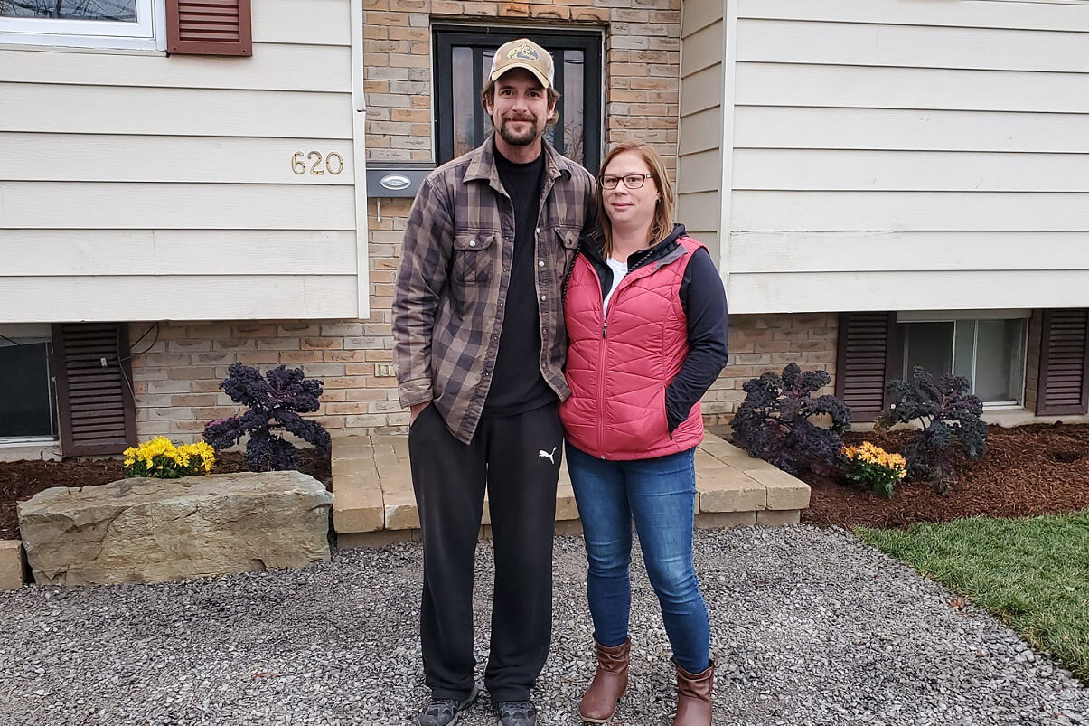 man and woman outsidet their home