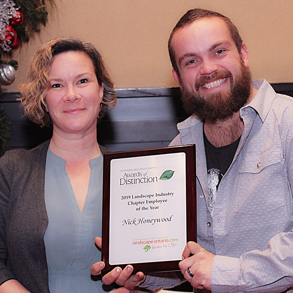 two people one holding a plaque