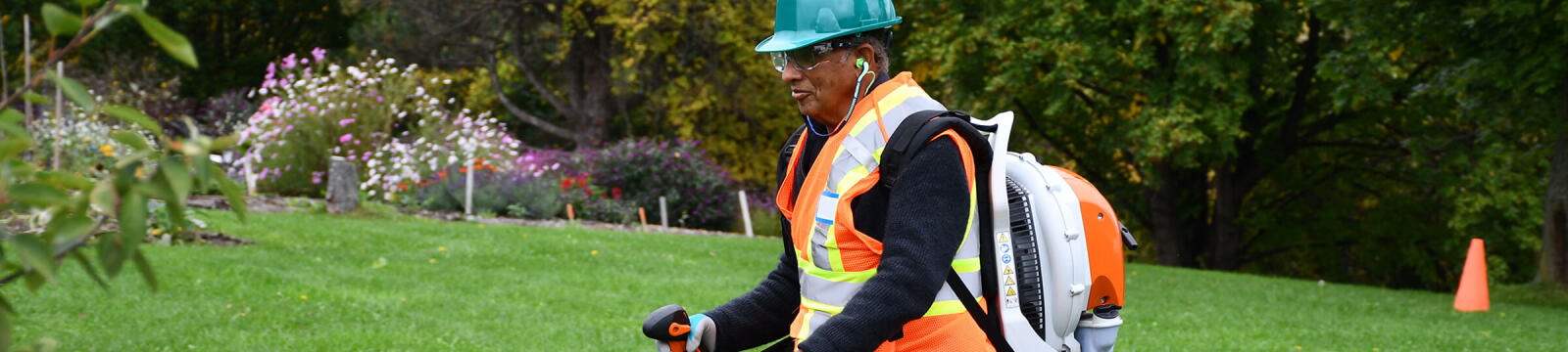 man using a blower in a garden