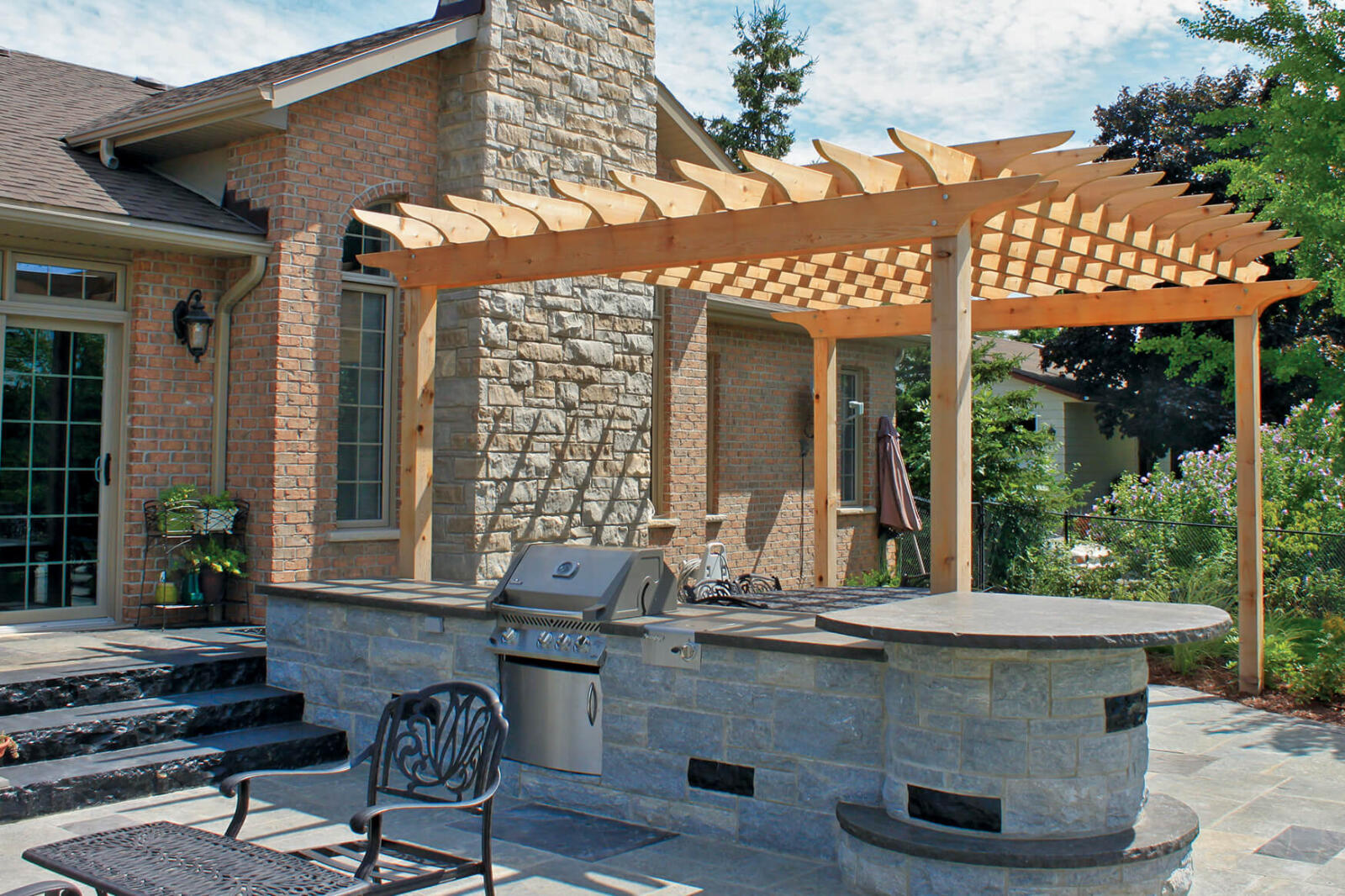 arbor and stone steps in a backyard