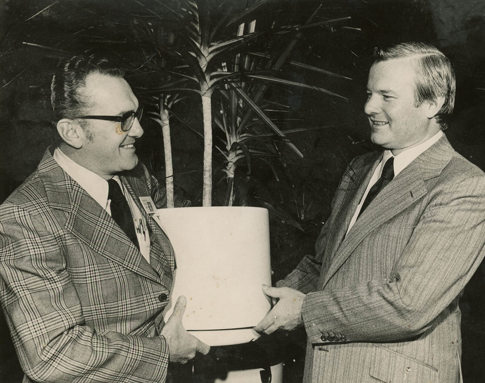 old photo a man presenting another man with a certificate