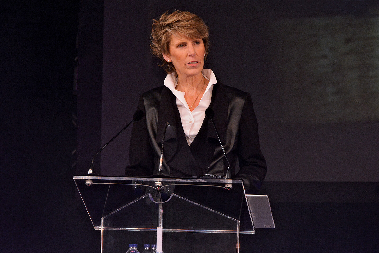 woman at a podium addressing and audience