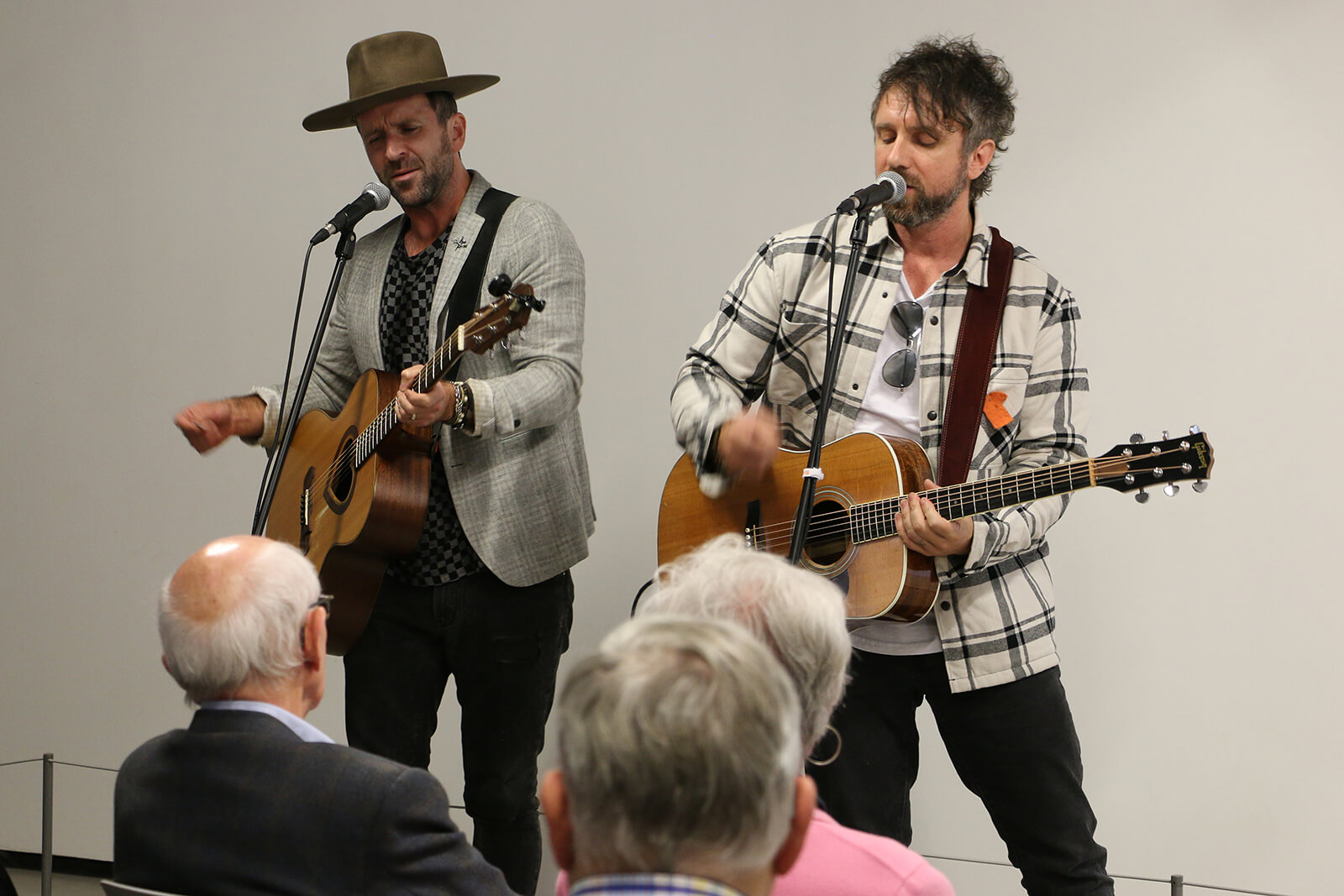 two men playing guitar