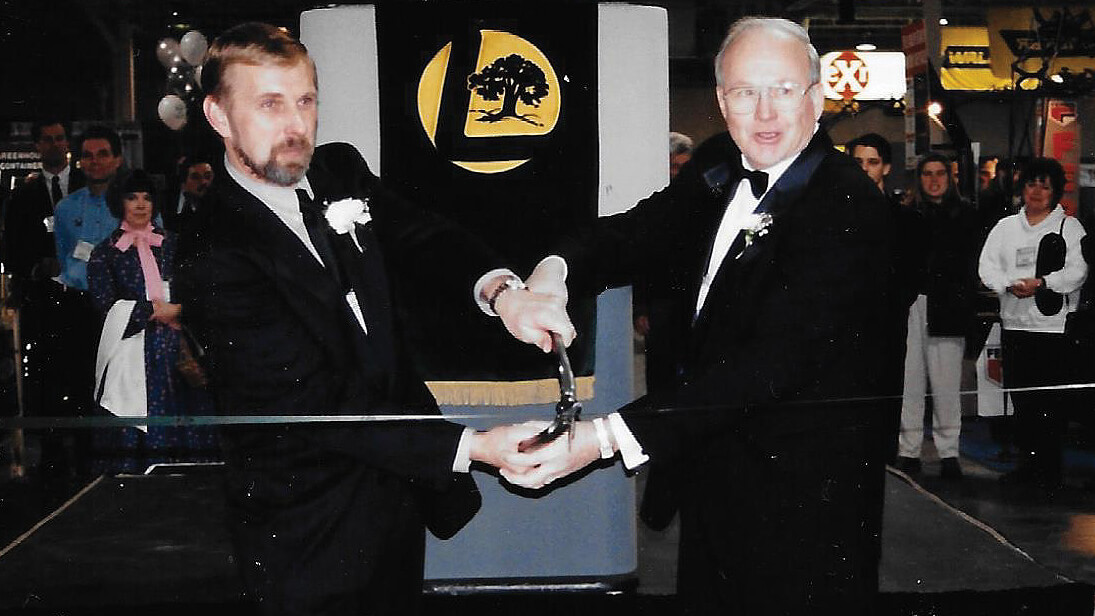 two men cutting a ribbon