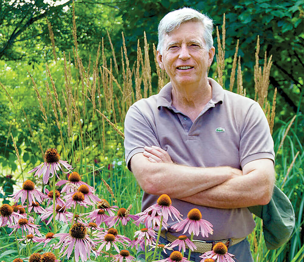 man standing in a garden
