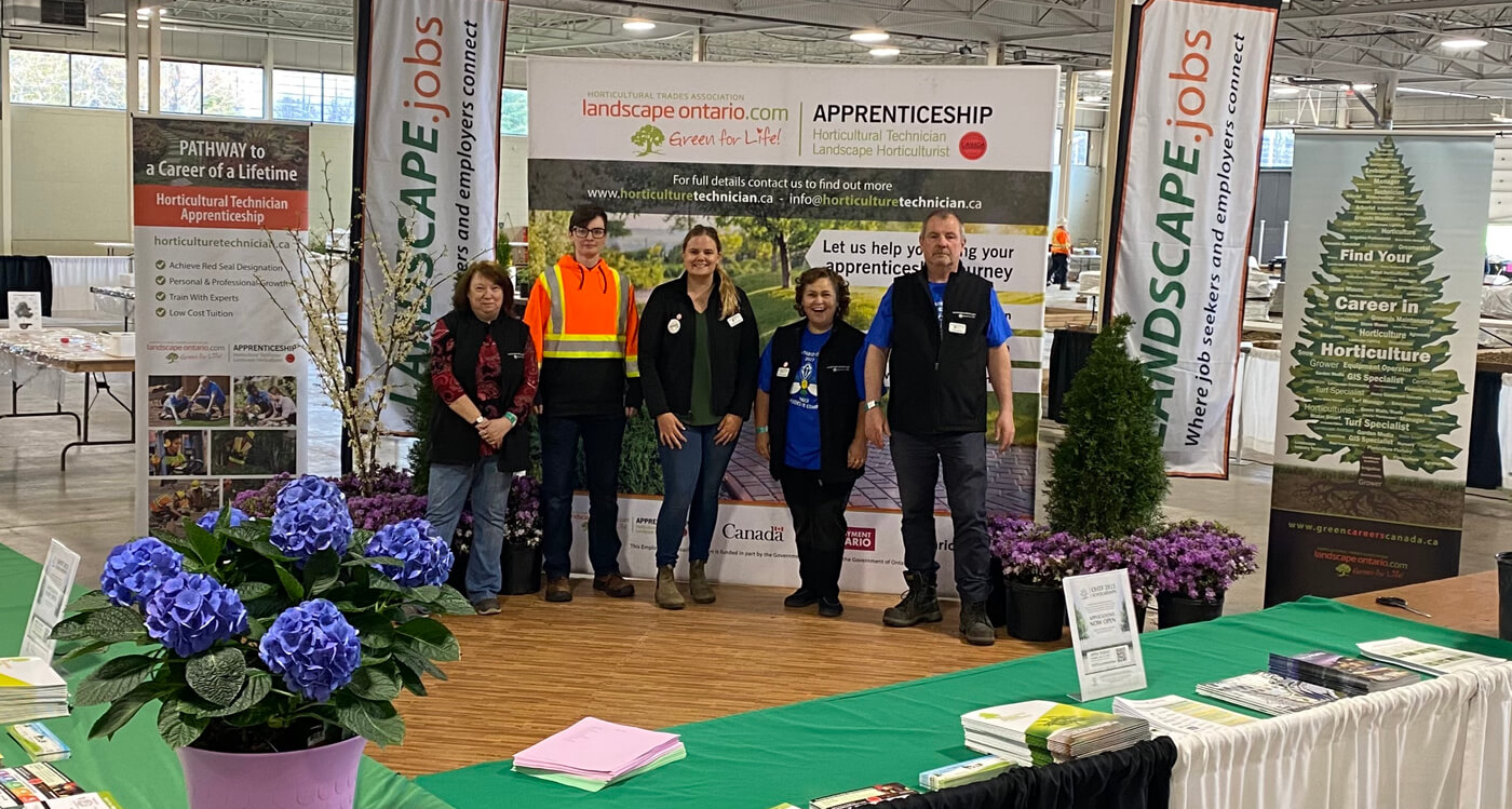 group of people standing in a booth