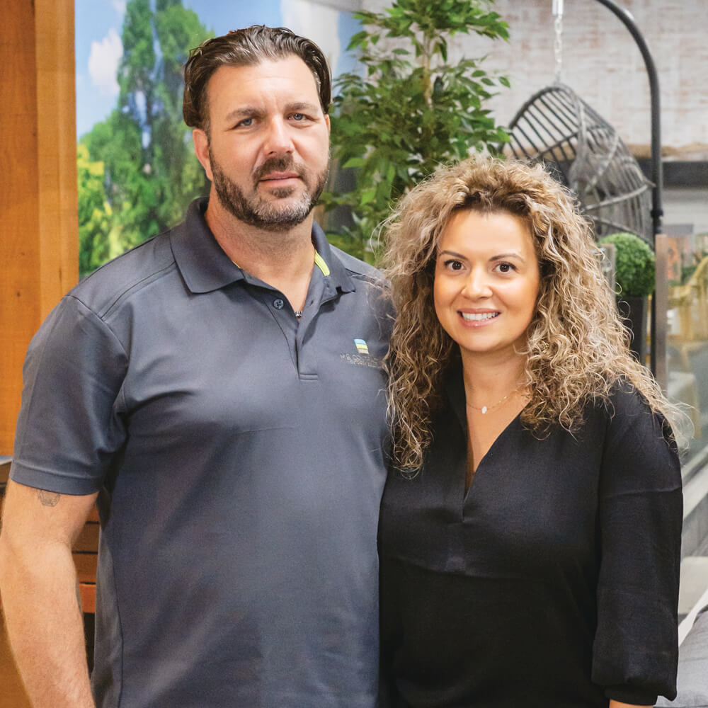 man and a woman standing in a showroom