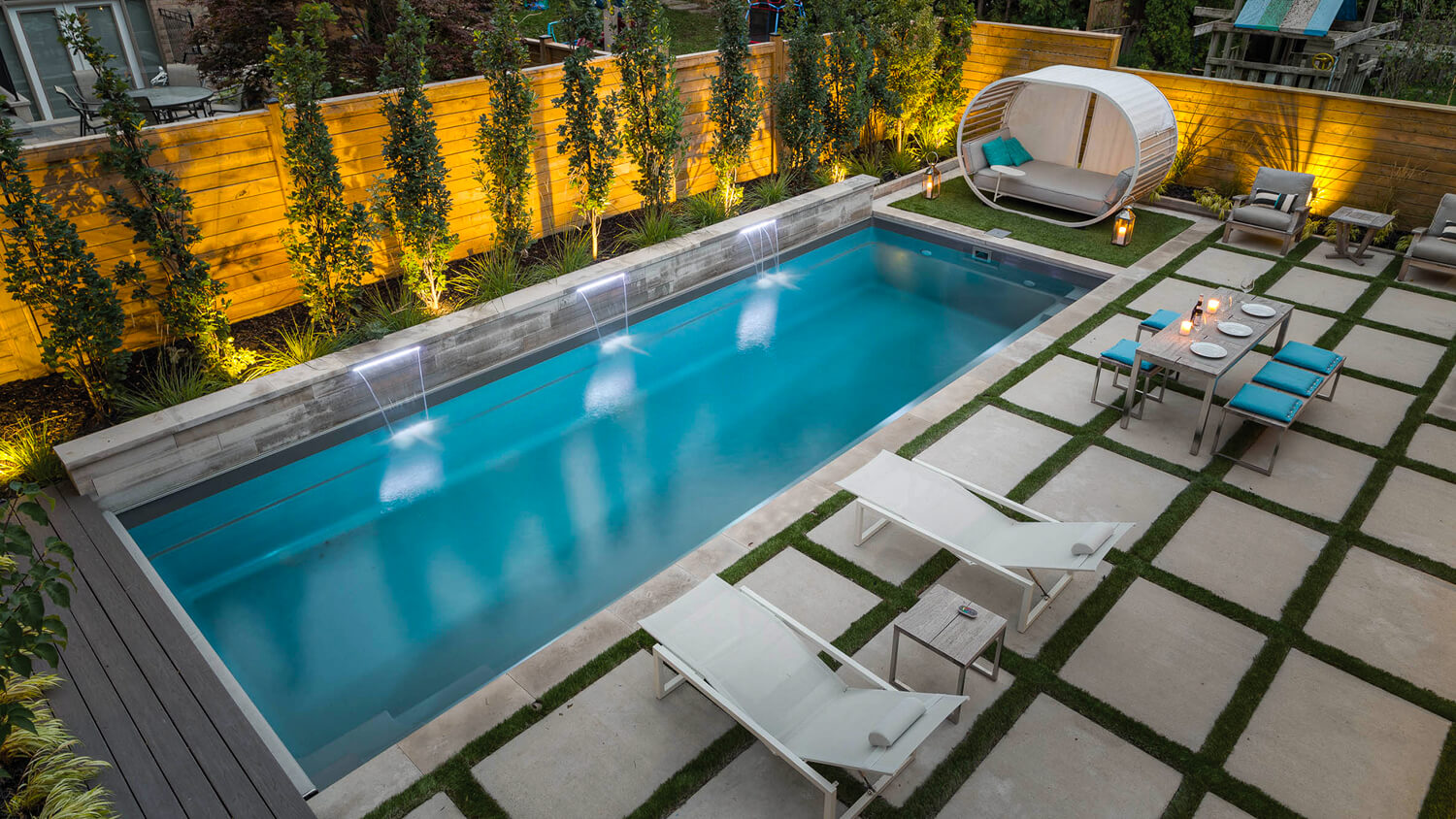 backyard with a pool lighting and seating area