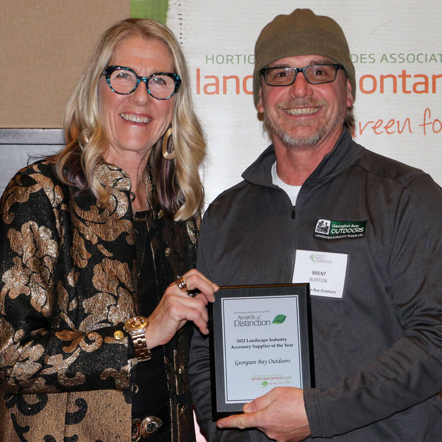 two people one holding a plaque