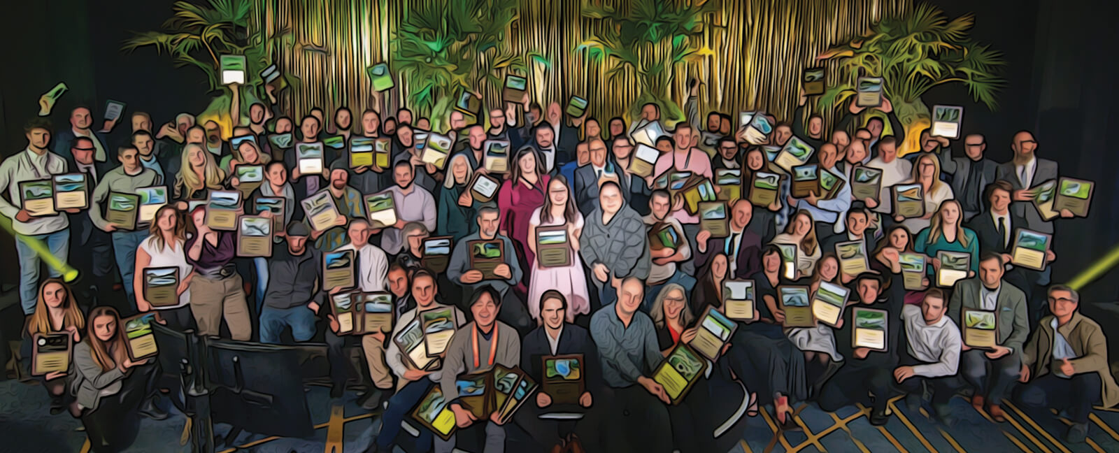 large group of people on a stage with awards