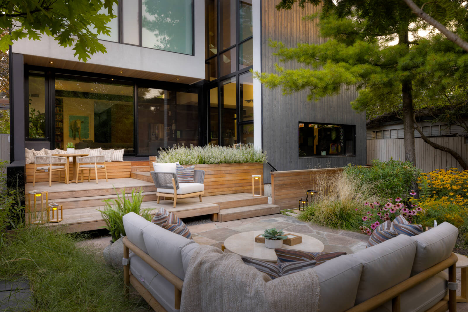 award winning landscaped backyard with lots of natural wood and a seating area