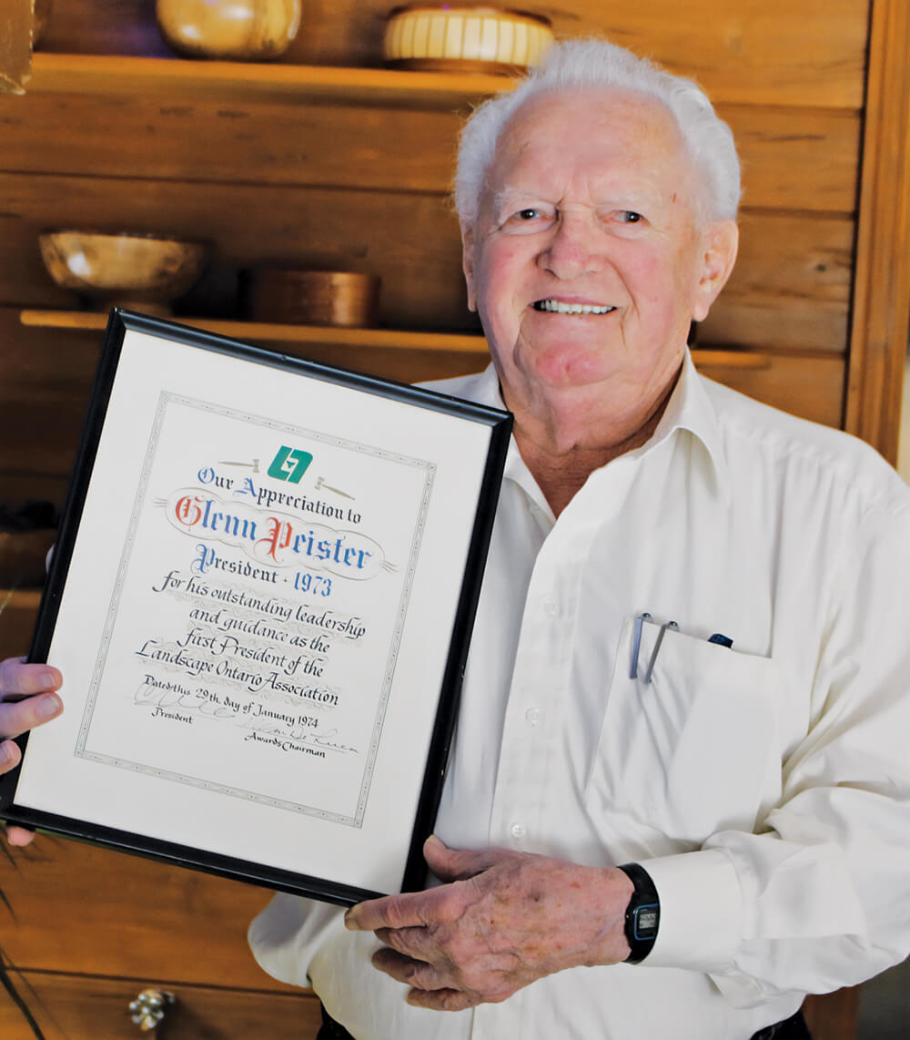 man holding a framed certificate