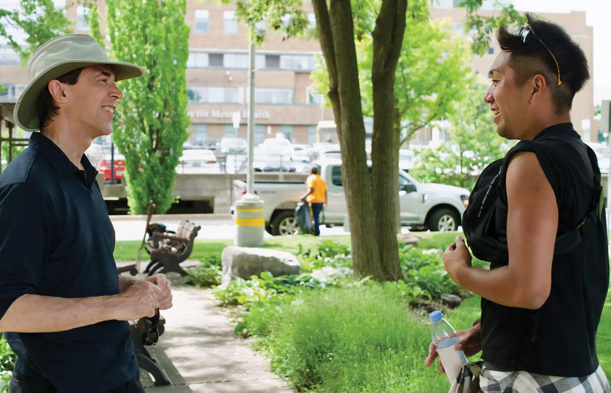 two men talking outside