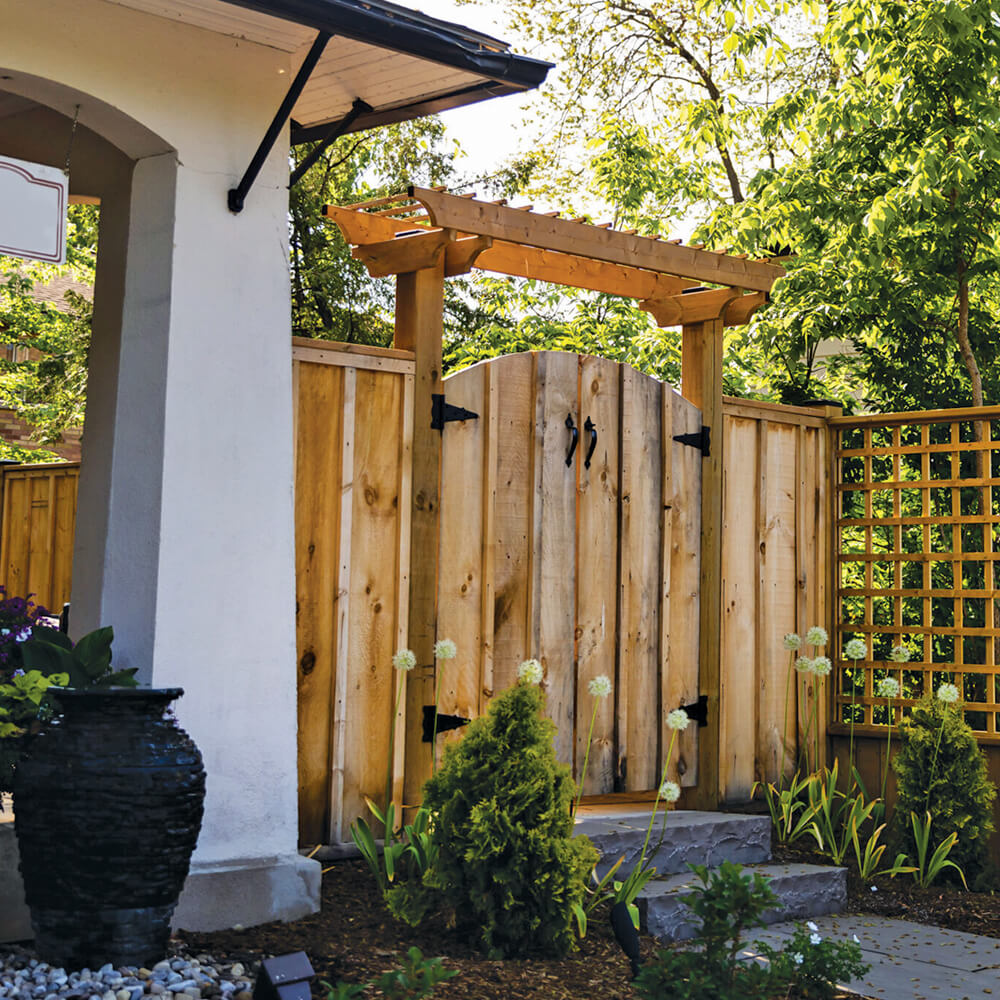 wood gate and fence at the side of a house