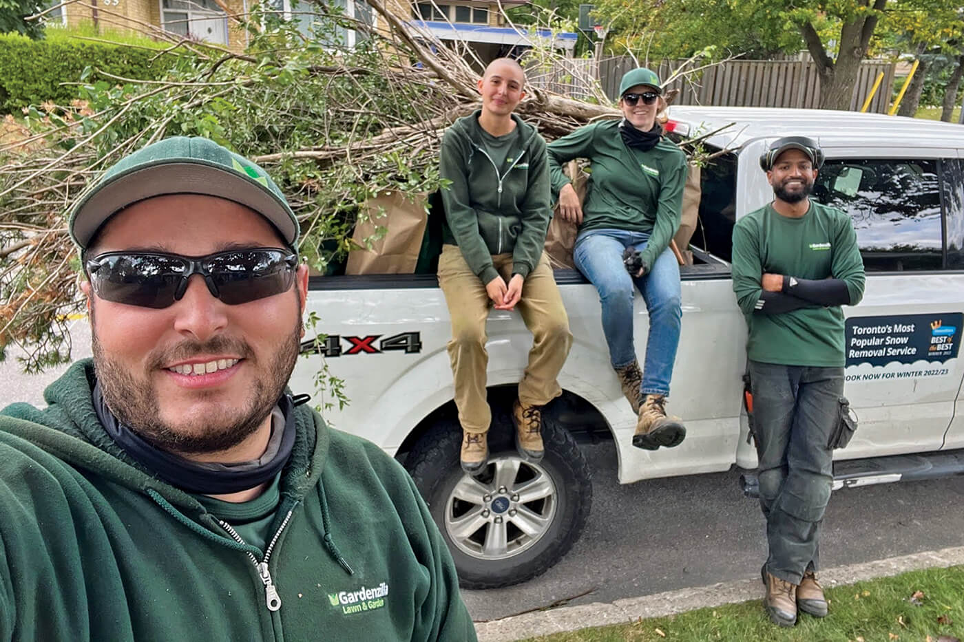 person taking a selfie with others in the background