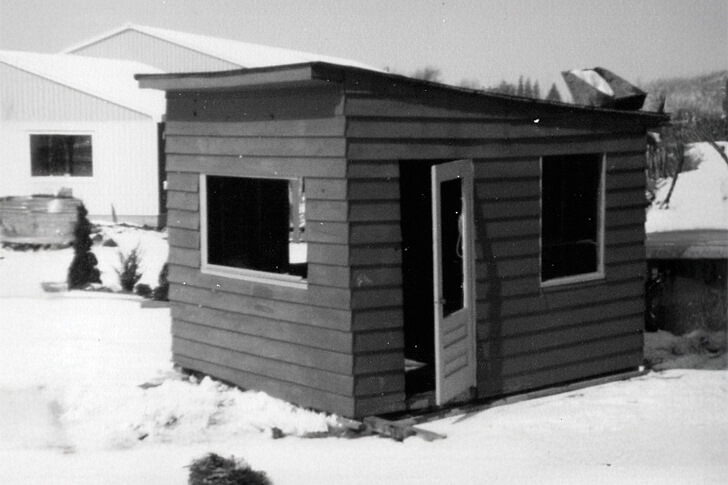 black and white photo of a small wooden shed