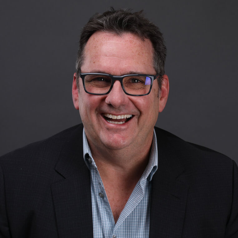 man wearing glasses and smiling