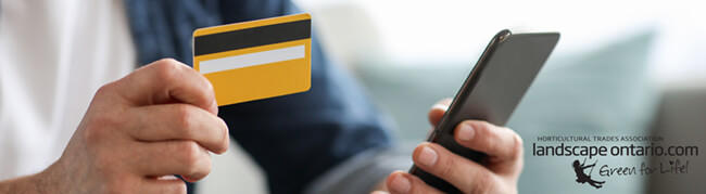man holding a credit card and smartphone