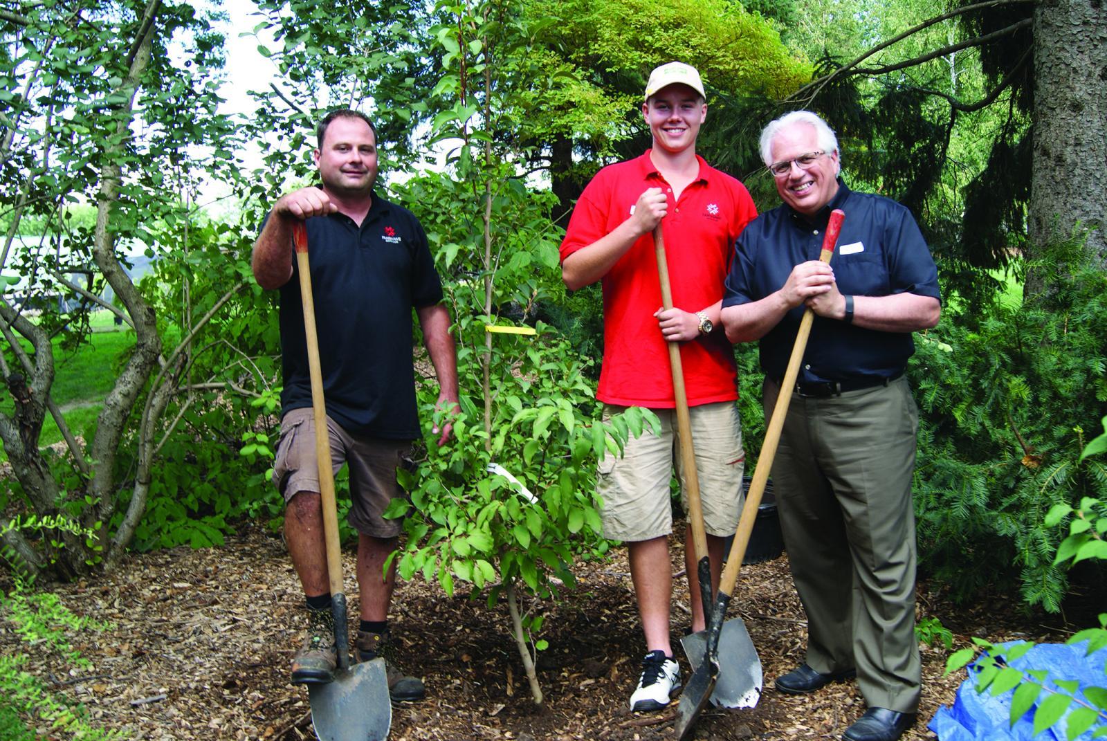 LO Executive Director Tony DiGiovanni (right) planted a Stewartia at Cuddy Gardens alongside the first (Tim Elliott, left) and most recent (Easton Klaudi) recipients of the Tony DiGiovanni Scholarship.
