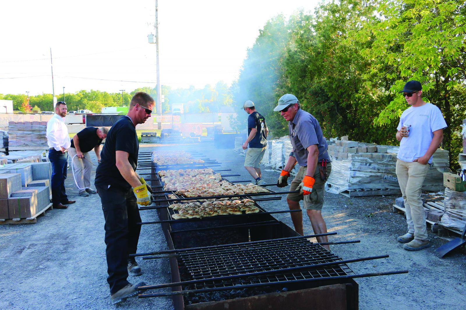 Charcoal cooked chicken, led by Paul DeGroot (right), is the cornerstone of the Golden Horseshoe Chapter’s annual social event.