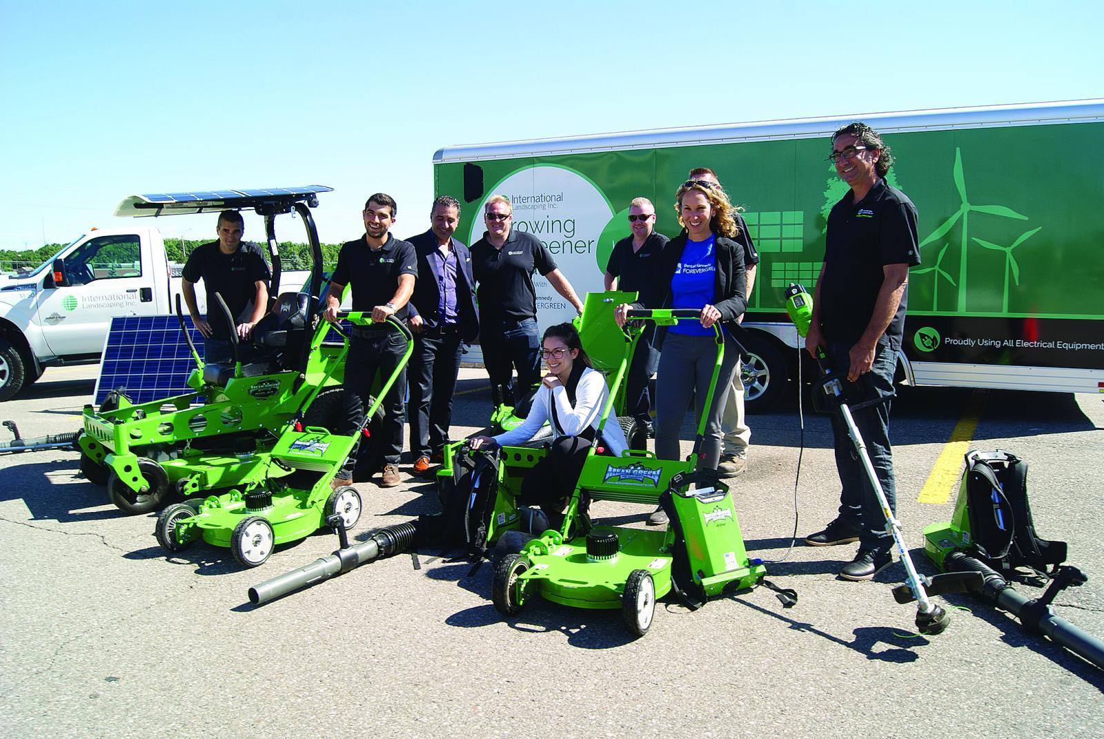 The team from International Landscaping proudly displaying solar and electric grounds maintenance equipment.