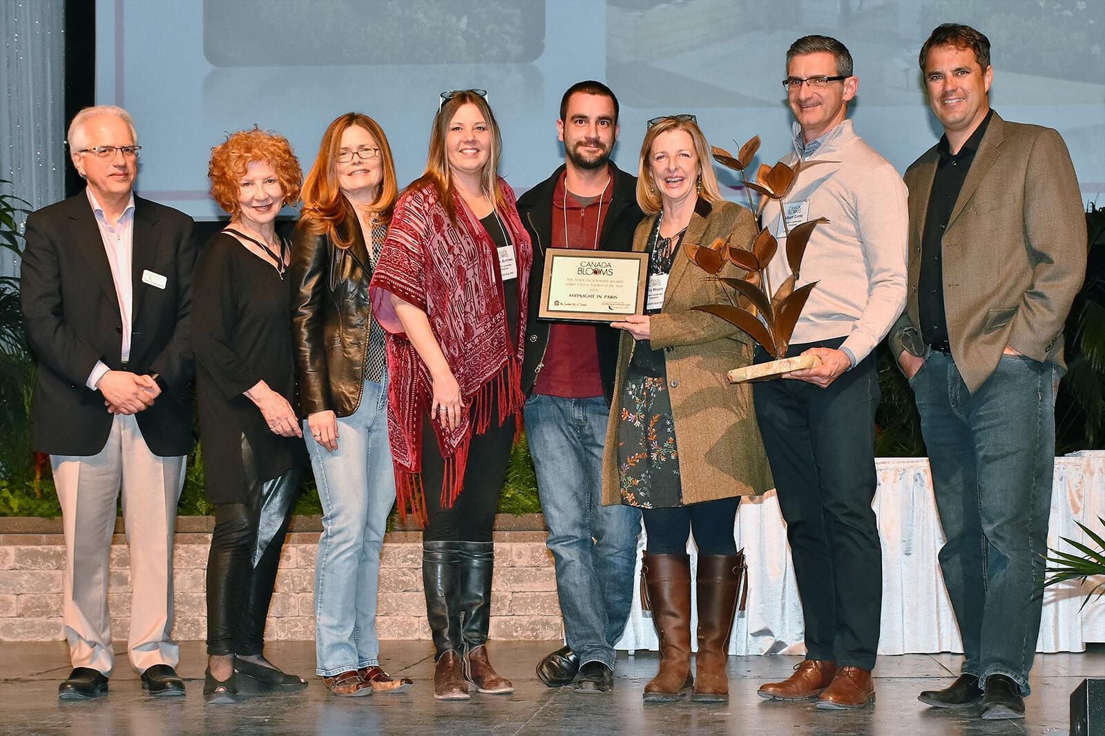 Modern Landscape Designers and Trimatrix Construction receive the Garden of the Year Award on stage at Canada Blooms.