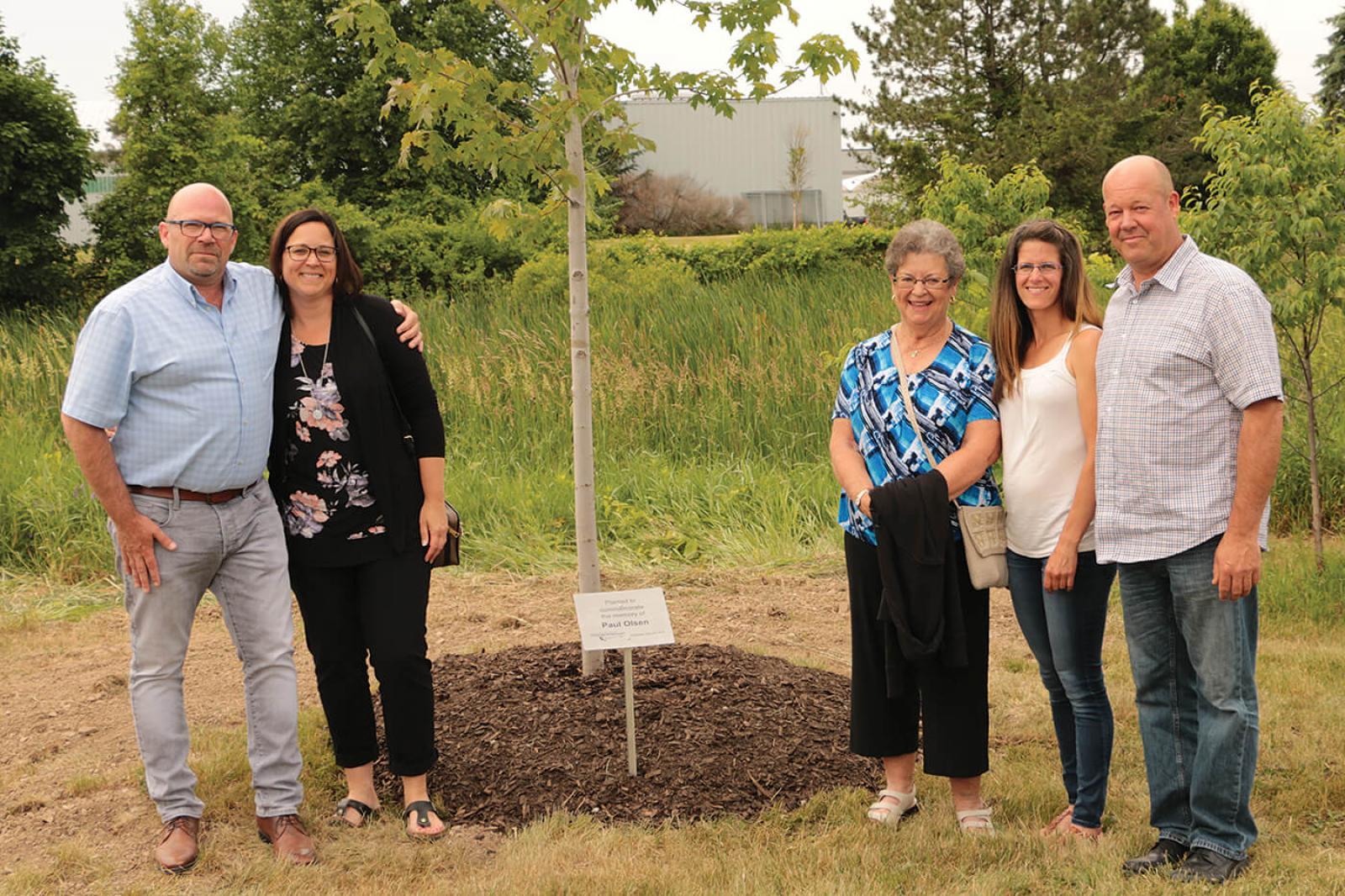 Members of the Olsen family gather around a newly planted Autumn Blaze maple in memory of the late Paul Olsen. (L-R): Jeff, Diane, Linda, Jennifer and Peter Olsen.