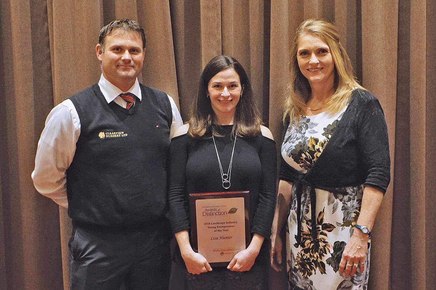 Michael LaPorte (left) and Laurie Ann Stuart (right) present Lisa Hunter with the chapter’s inaugural Young Entrepreneur of the Year Award.