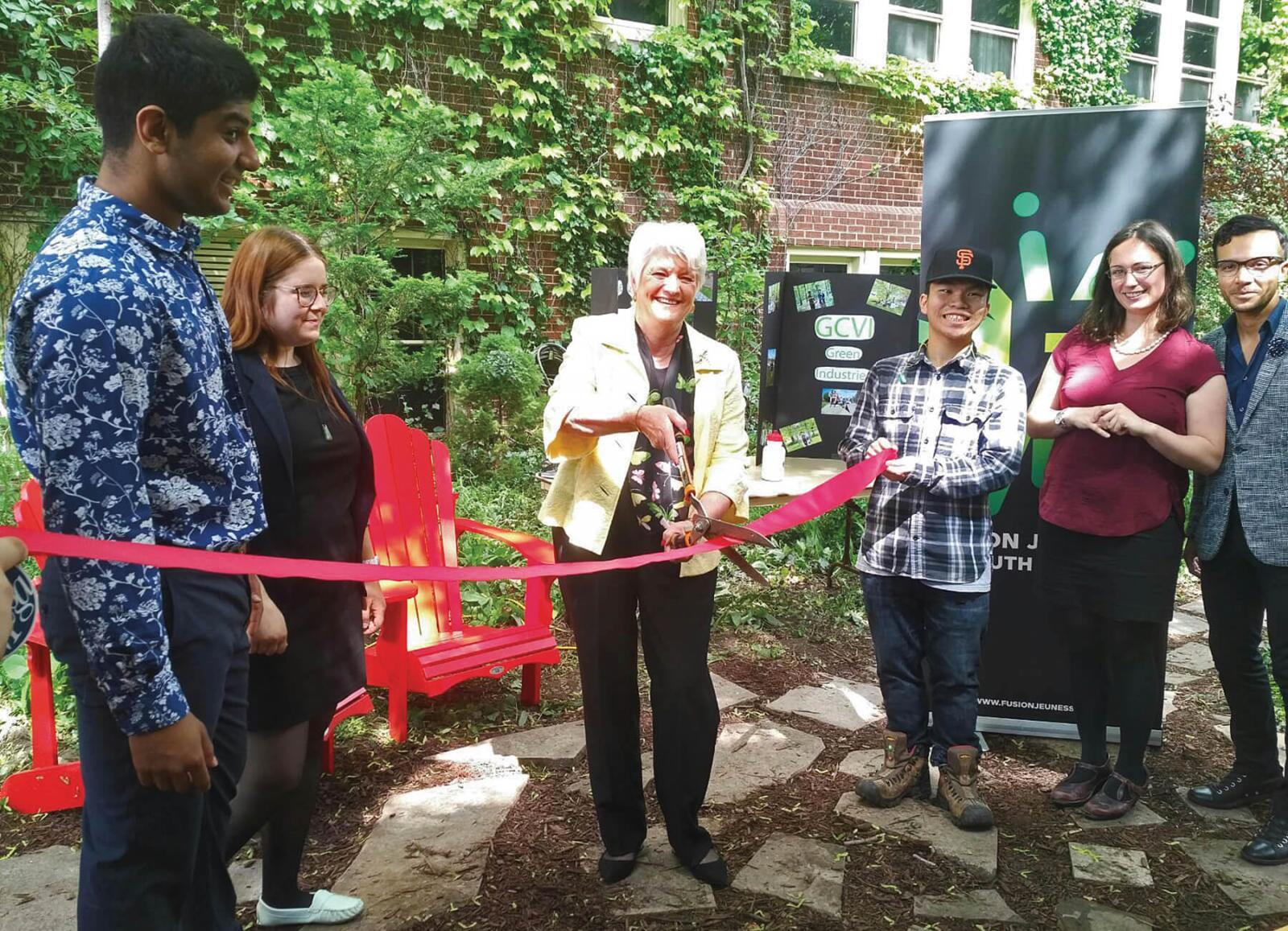 Students accompany Liz Sandals, MPP Guelph at a ribbon cutting ceremony to celebrate the new garden.
