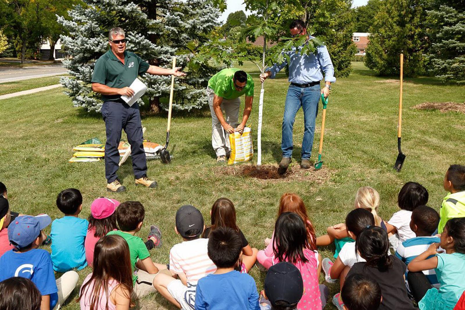 Clintar’s Terry Nicholson (left) explains the positive effects of trees to a group of students at German Mills Public School in Markham.