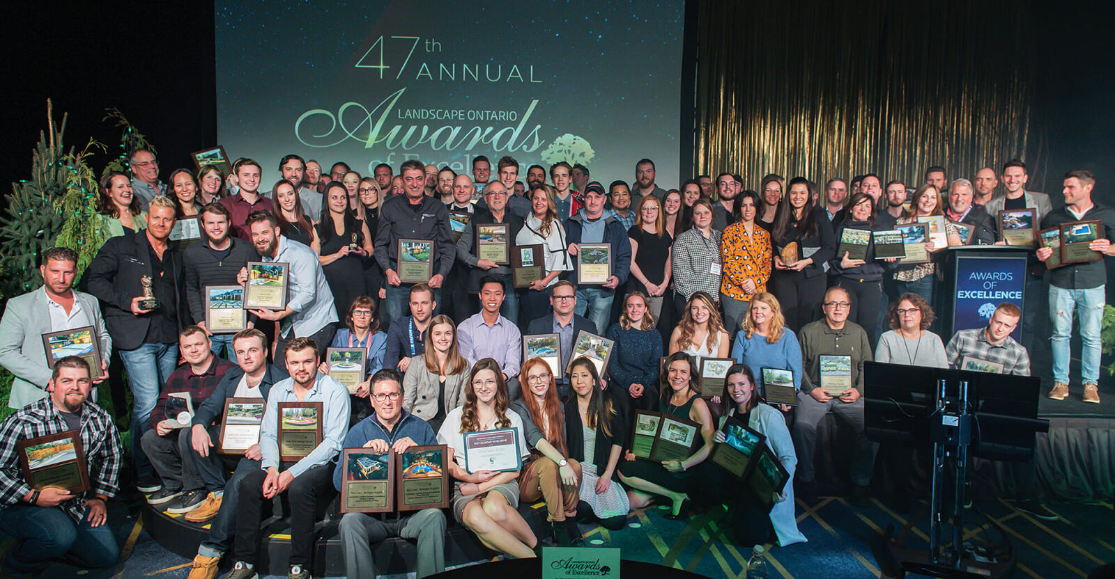 Winners gather on stage at the conclusion of the awards ceremony.