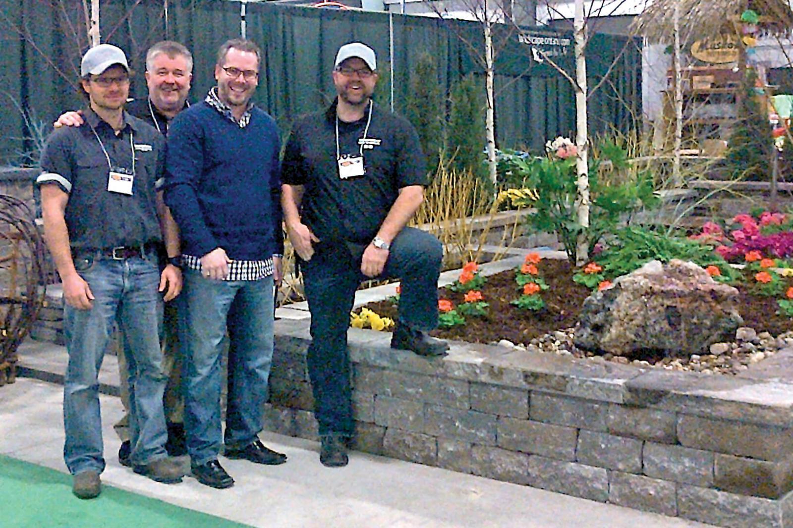 In the photo from left are Mike Reid and Rob Garby, both of Hansen Lawn and Gardens,  Michael Fulcher of Permacon and president of the Ottawa Chapter, Ed Hansen of Hansen Lawn and Gardens as they pose at the LO garden at the Ottawa Cottage and Back Yard Show.