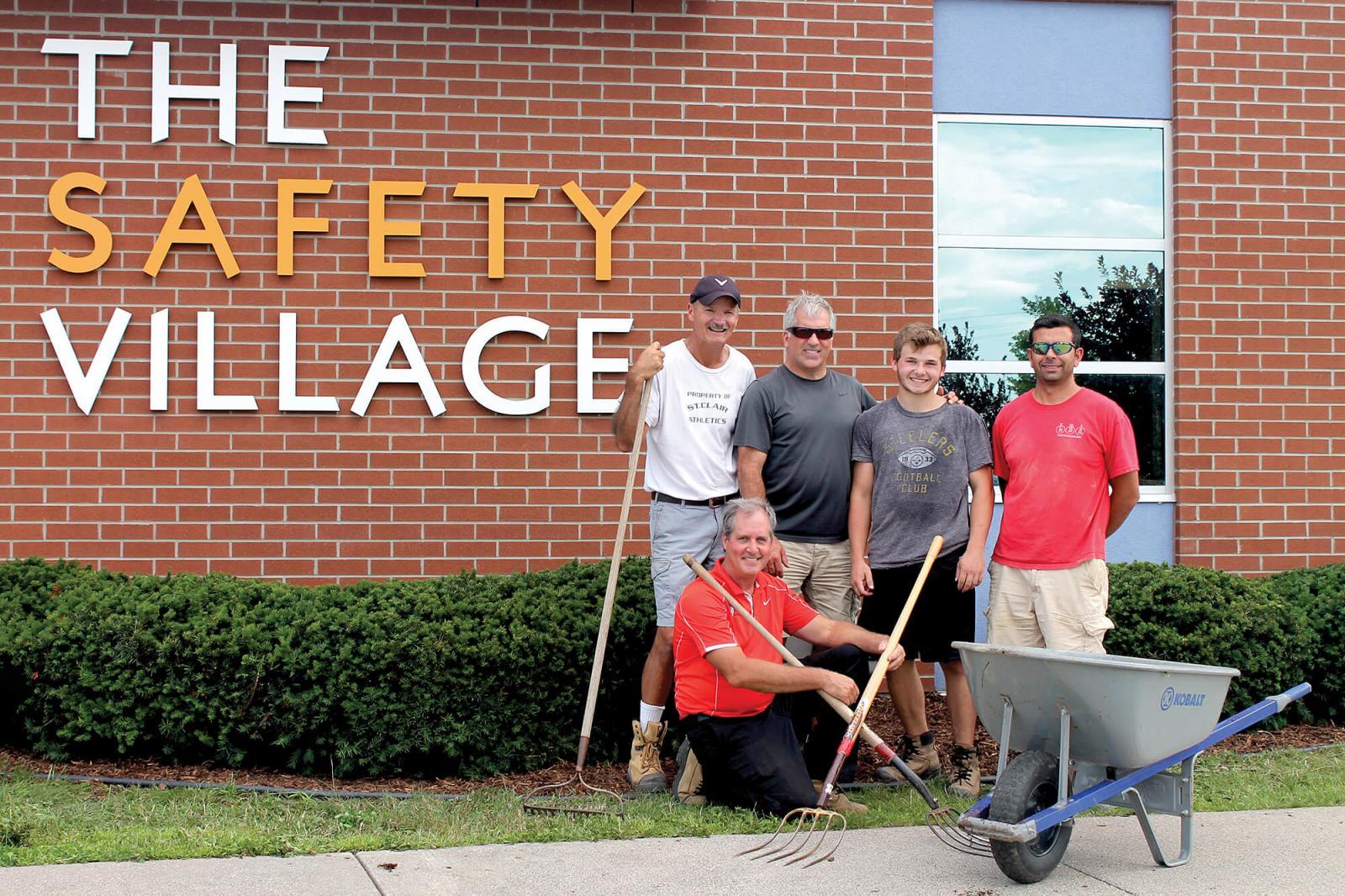 Volunteers from Windsor Chapter take a break from their work at Windsor Safety Village. In front is Garry Moore, with in back from left, Don Tellier, Chris Power, Mitchell Madej and Sal Costante. 