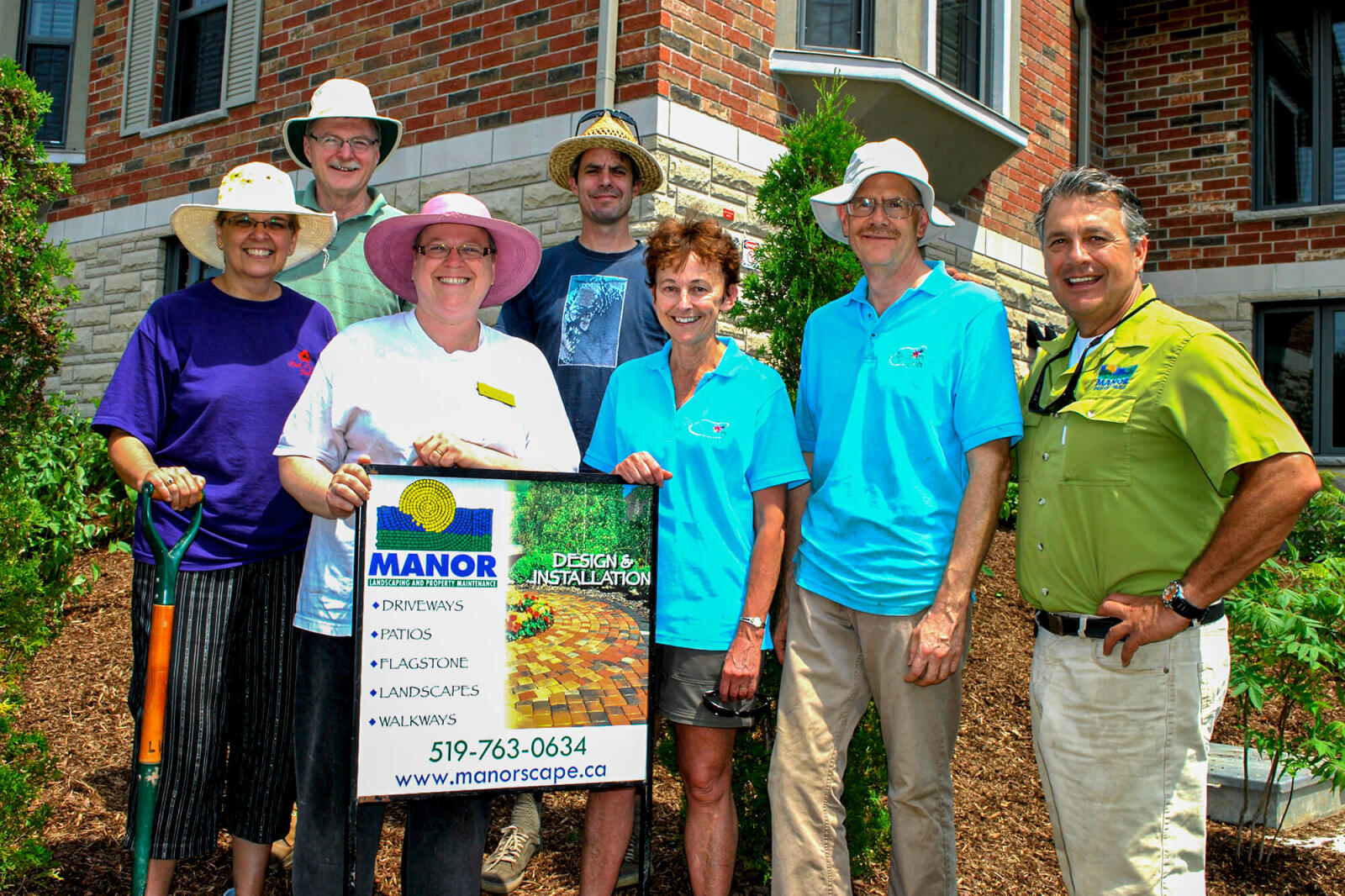 Volunteers praise Carlo Mann (right), owner of Manor Landscaping, for his support to beautify the grounds at the Guelph hospice.