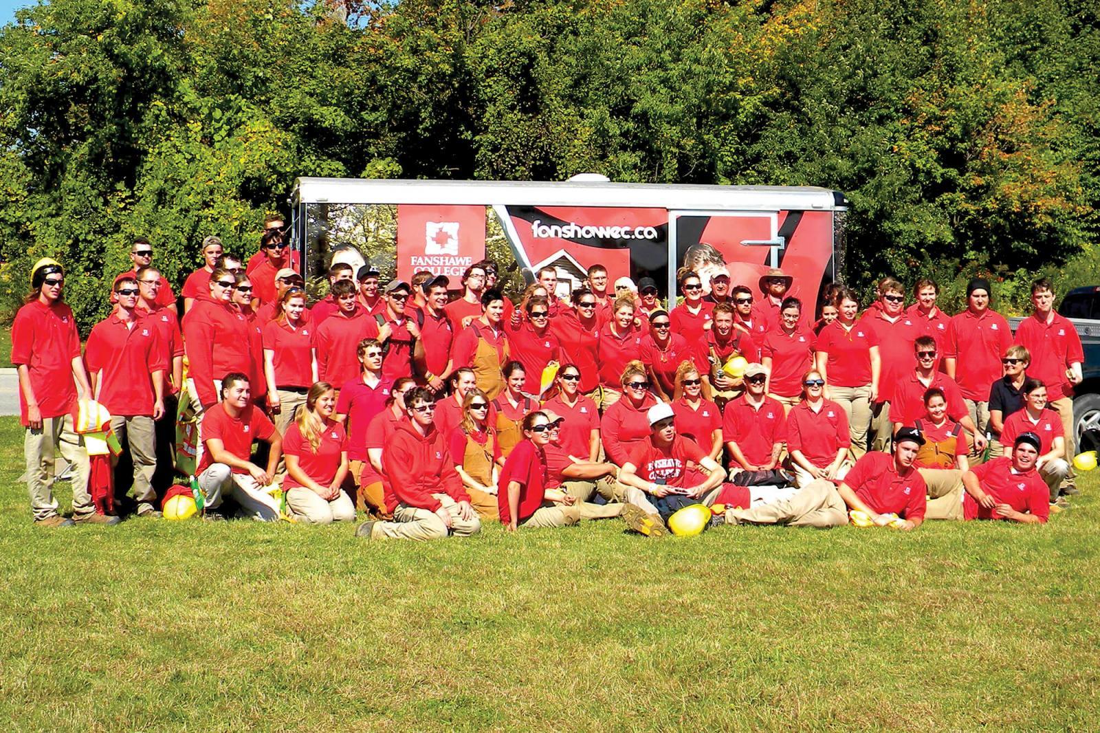 Fanshawe College students, dressed in their distinctive red, offered their services to help guide volunteers to plant over 400 trees along the Veterans Memorial Parkway in London.