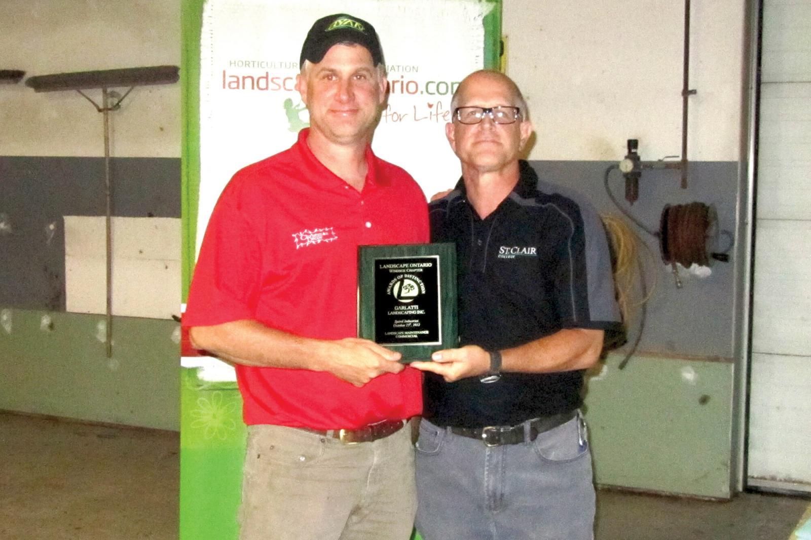 Dan Garlatti, left, of Garlatti Landscaping in LaSalle receives one of his 2012 Awards of Distinction from Chapter director Jay Terryberry at the 2012 Awards of Distinction.