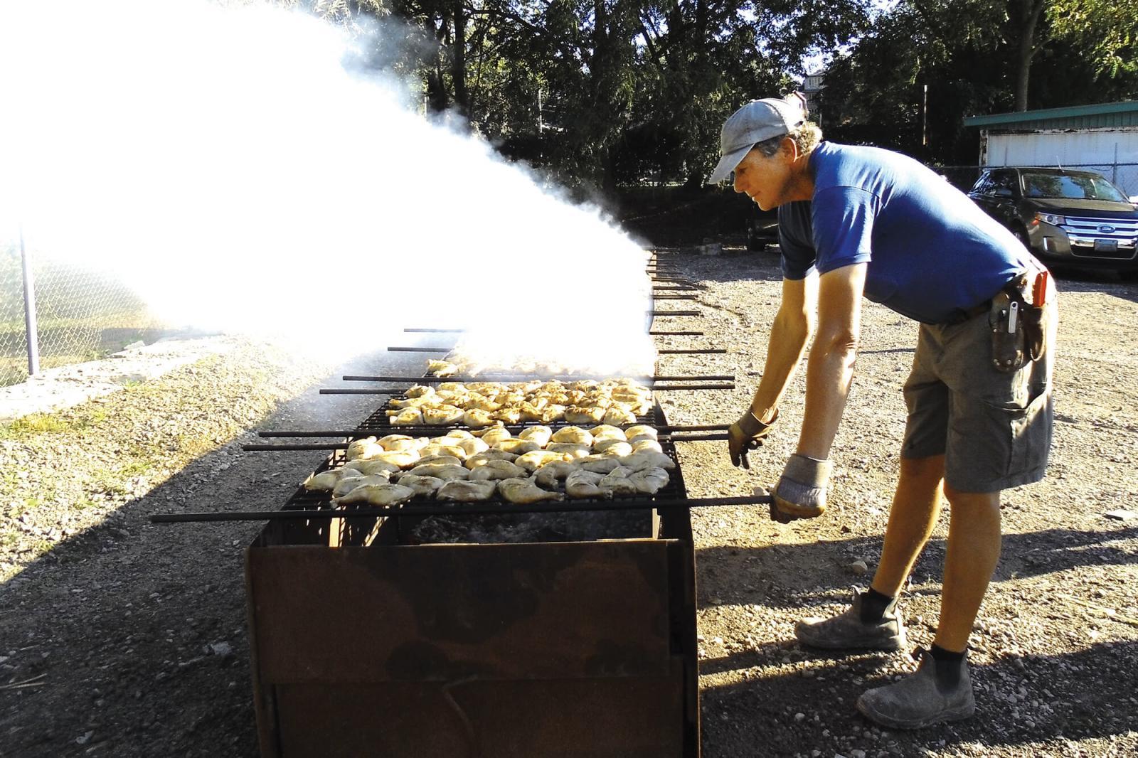 Paul DeGroot continues his annual task of barbecuing hundreds of chickens.