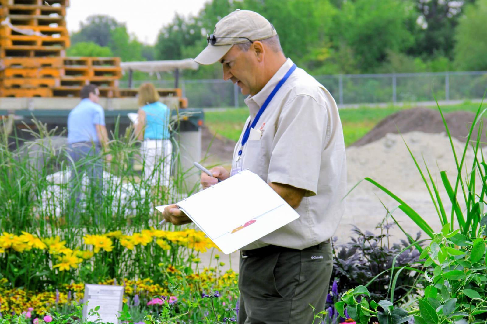 Michael Pascoe of Fanshawe College was kept busy judging plant material at this year’s auction.