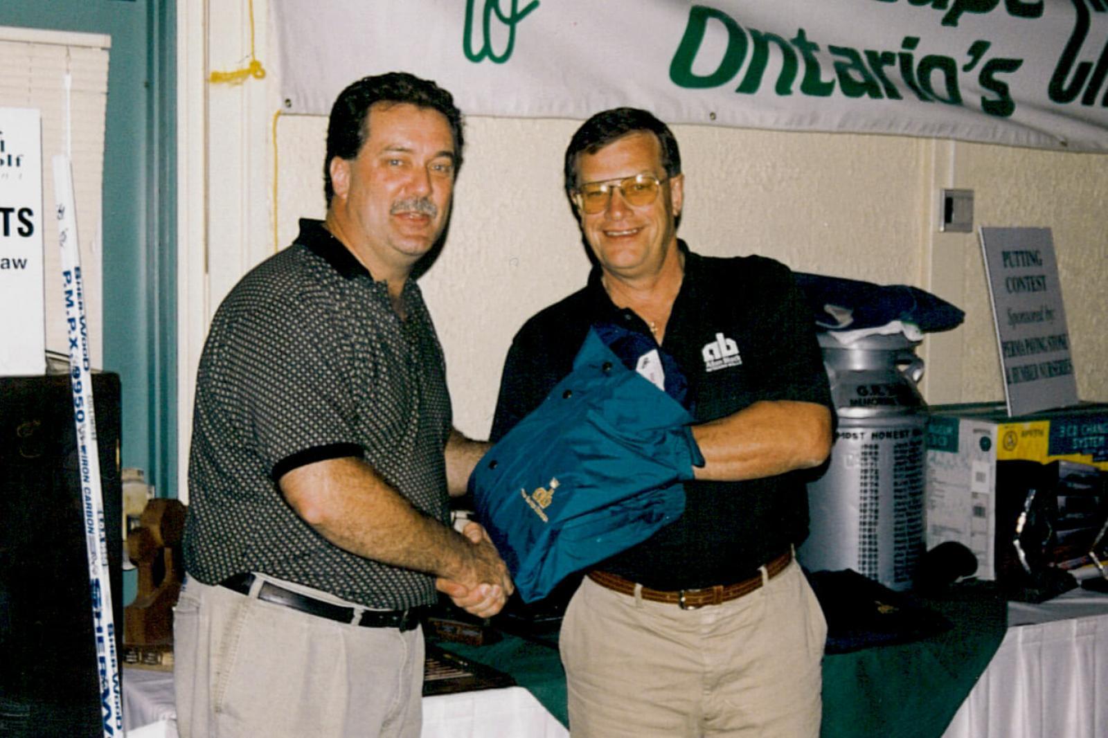 The Toronto Chapter’s Dick Sale Memorial Charity Golf Tournament raised over $1,500 towards the Hospital for Sick Children. In photo, Maurice Le Blanc, left, receives the prize for the longest drive from donor Marty Lamers of Allan Block.