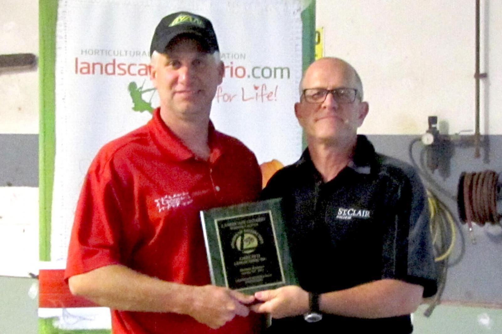 Dan Garlatti accepts one of the three awards his company Garlatti Landscaping won in the Windsor Chapter Awards of Distinction from Jay Terryberry.