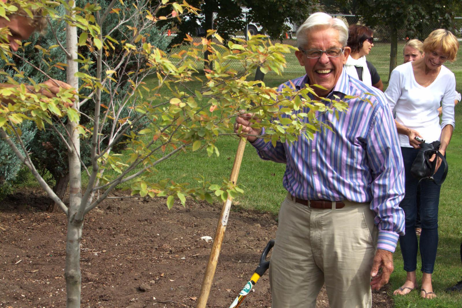 Barry Benjamin, a past president of LO, helps plant a tree at LO home office in Milton to mark National Tree Day.