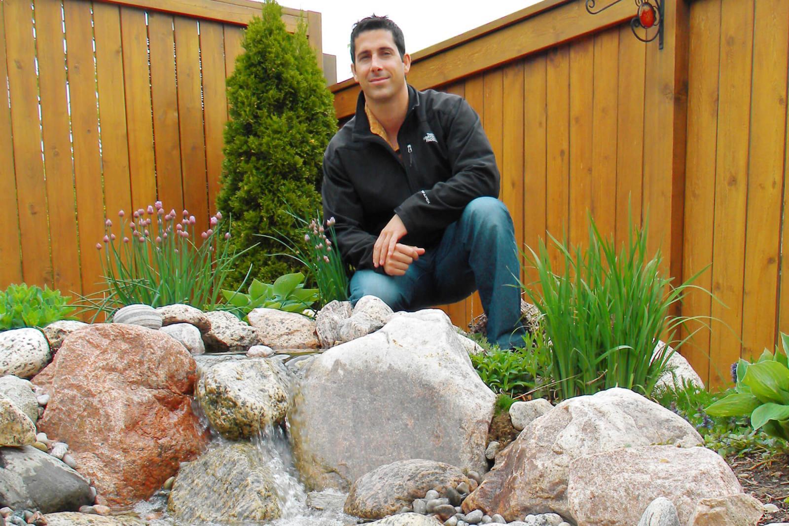 Chris Le Conte of Smart Watering Systems demonstrates harvesting rainwater within attractive landscape.