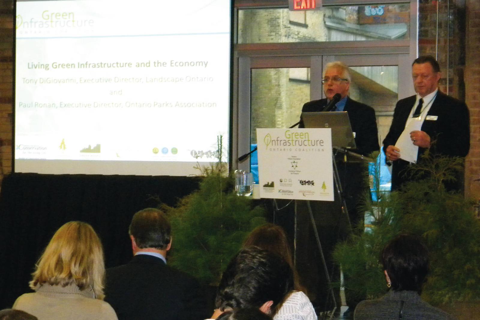 Tony DiGiovanni, left, and Paul Ronan speak to the 150 gathered for the Green Infrastructure Coalition’s strategy launch at Evergreen Brick Works in the Don Valley.