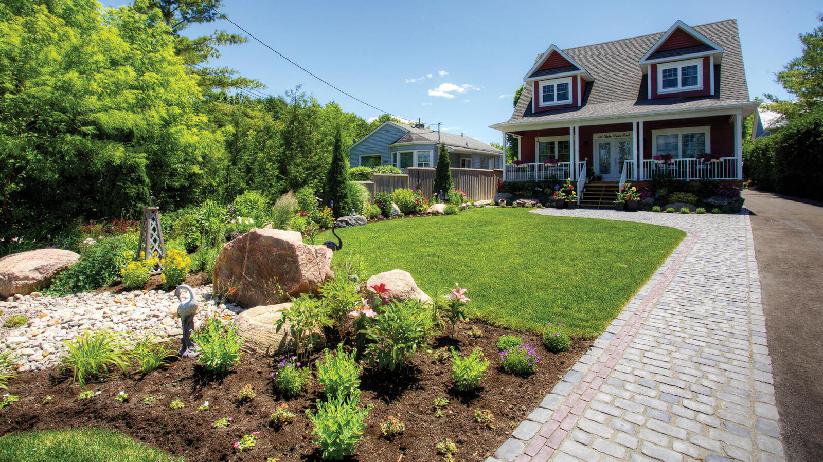 Anna van Maris blends  low impact elements into  all Parklane Landscapes  designs, including native  plantings, and permeable pavers  seen in this residential project.